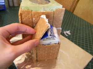 Putting roof on gingerbread house