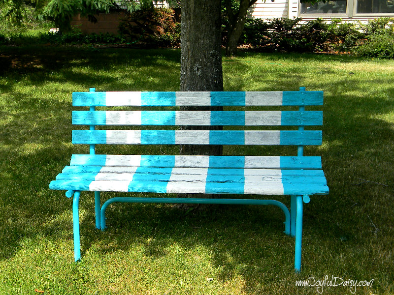 painted bench by tree